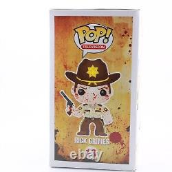 Funko Pop The Walking Dead Bloody Rick Grimes Harrison's Comics Exclusive #13<br/>	
<br/>
Funko Pop Le Walking Dead Bloody Rick Grimes Harrison's Comics Exclusive #13